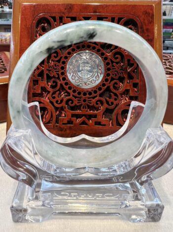 A round marble plate with a carved design on it.