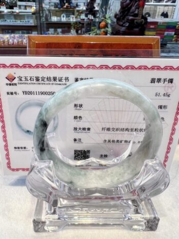 A clear glass bangle sitting on top of a table.