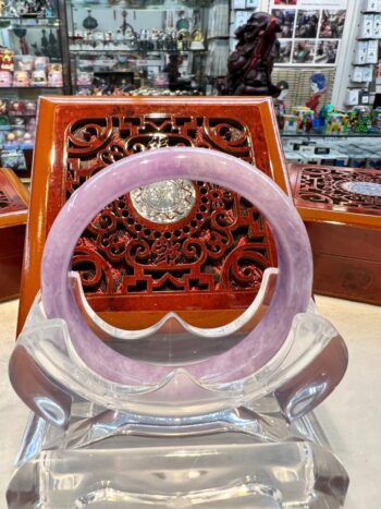 A purple glass ring sitting on top of a wooden table.