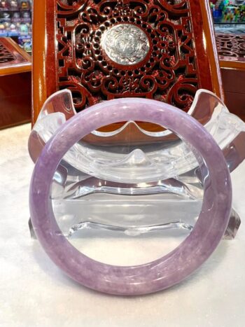 A purple bangle sitting on top of a table.