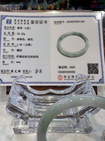 A green jade ring is on display in an asian store.