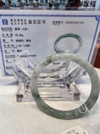 A green jade bangle sitting on top of a table.