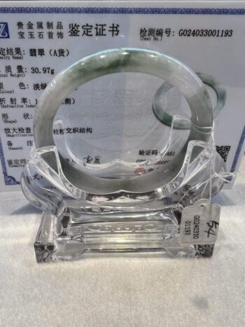 A glass sculpture of an asian bracelet.