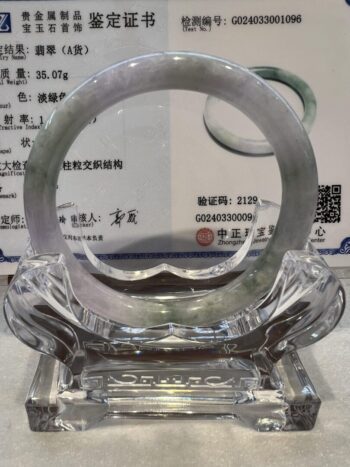 A glass sculpture of an elephant with a circular design.