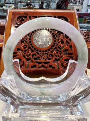 A large white jade ring sitting on top of a table.