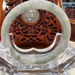 A large round white jade bangle sitting on top of a table.