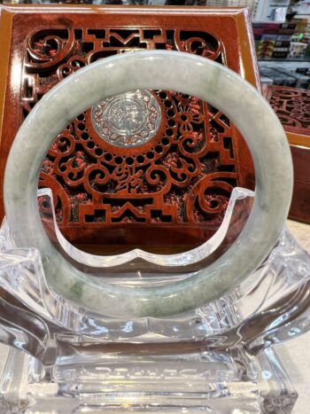 A large round white jade bangle sitting on top of a table.