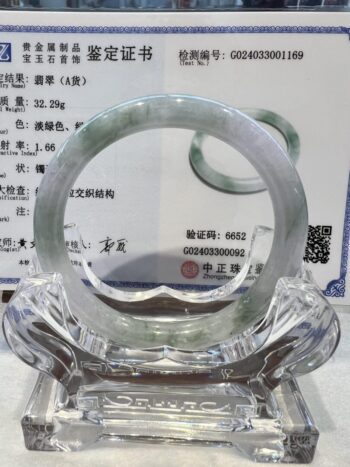 A close up of an asian ring on top of a glass object.