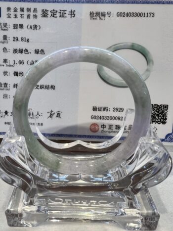 A glass bowl with some type of bracelet on it