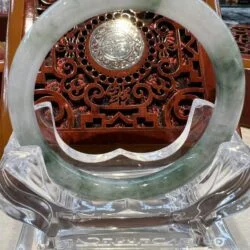 A glass plate with a wooden carving on it.