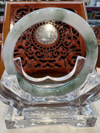 A glass plate with a wooden carving on it.