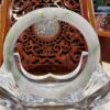A large white jade ring sitting on top of a wooden chair.