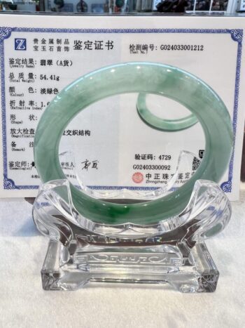 A glass sculpture of an asian symbol.