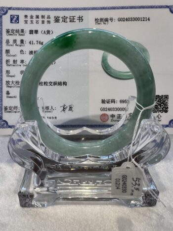 A glass sculpture of an ouroboros snake.