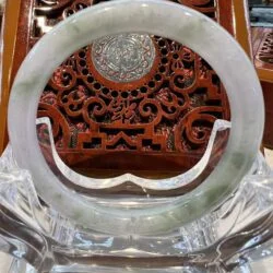 A close up of an asian style carved wooden object.