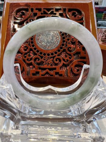 A close up of an asian style carved wooden object.