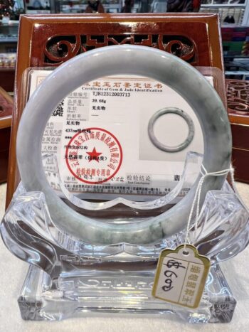 A round glass display case with a tag on it.