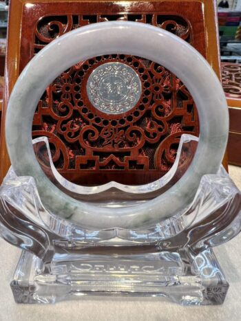 A round glass plate with a carved wooden background.