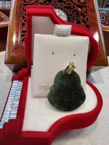 A green christmas tree ornament sitting on top of a table.