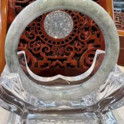 A round glass sculpture with a clock on it.