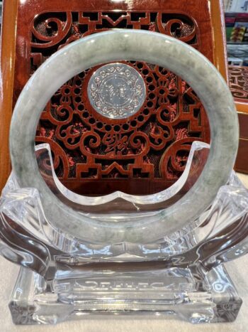 A round glass sculpture with a clock on it.