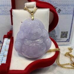 A purple jade buddha sitting in a red box.