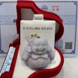 A silver buddha statue sitting in a red box.