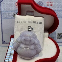 A silver buddha sitting in a red box.