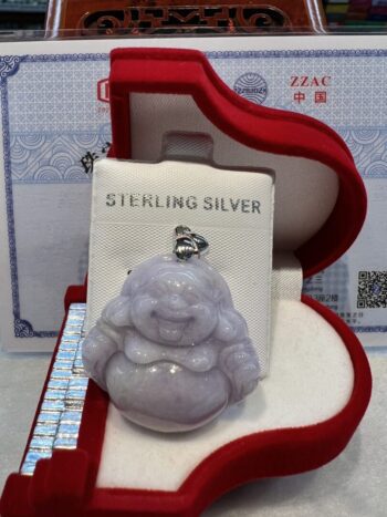 A silver buddha sitting in a red box.