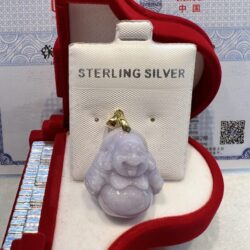 A silver buddha is sitting in the box.