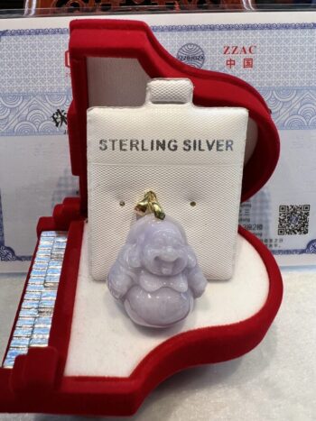 A silver buddha is sitting in the box.