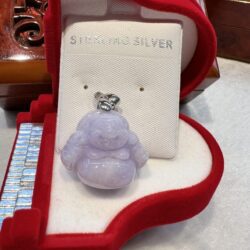 A small purple buddha is sitting in the box.