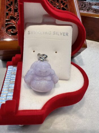 A small purple buddha is sitting in the box.