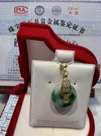 A green and white necklace in a red box.