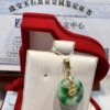A green and white pendant sitting in a red box.