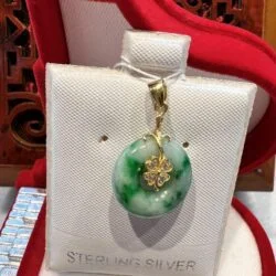 A green and white pendant sitting on top of a red chair.