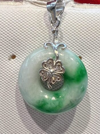 A green and white necklace with silver accents.