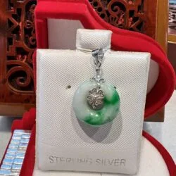 A green and white pendant sitting on top of a box.