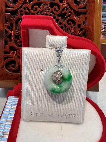 A green and white pendant sitting on top of a box.