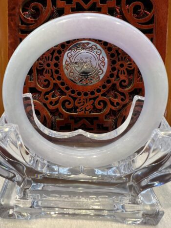 A white clock sitting on top of a glass table.