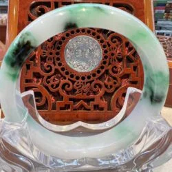 A green and white dish with a clock on it.