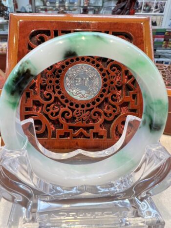 A green and white dish with a clock on it.