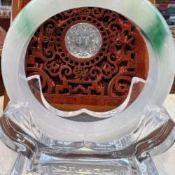 A clear glass plate with green and white design.