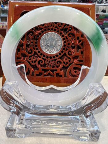 A clear glass plate with green and white design.