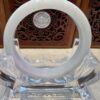 A white ring sitting on top of a glass table.