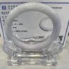 A white ring sitting on top of a clear glass holder.