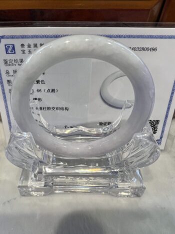 A white ring sitting on top of a clear glass holder.