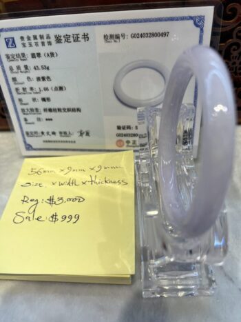 A glass pen holder with some notes on it