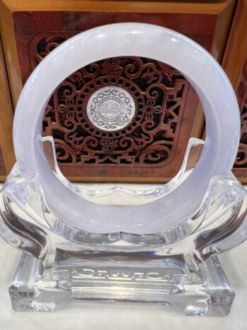 A clear glass sculpture with an intricate design.