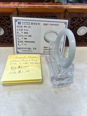 A white ring sitting on top of a clear holder.